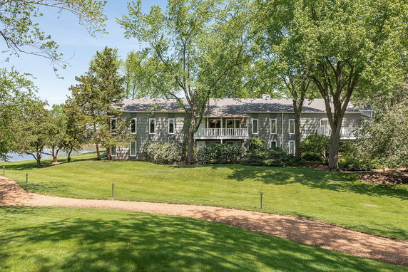 Front view of a house with multiple windows and a small balcony.