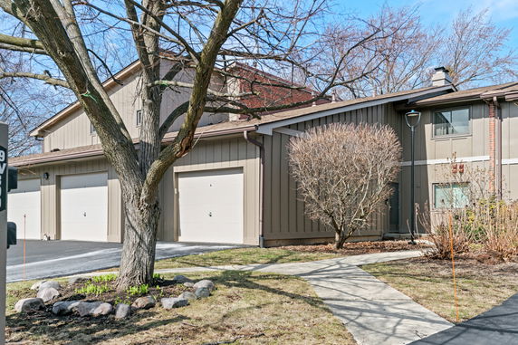 Front view of a two-story house with garage doors.