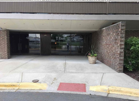 Front view of a building with glass doors and brick walls.