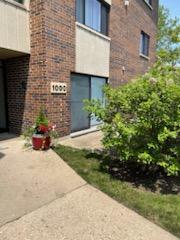 Front view of a brick multi-story building with windows.