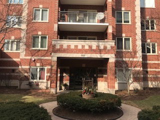 Front view of a multi-story building with a brick exterior.