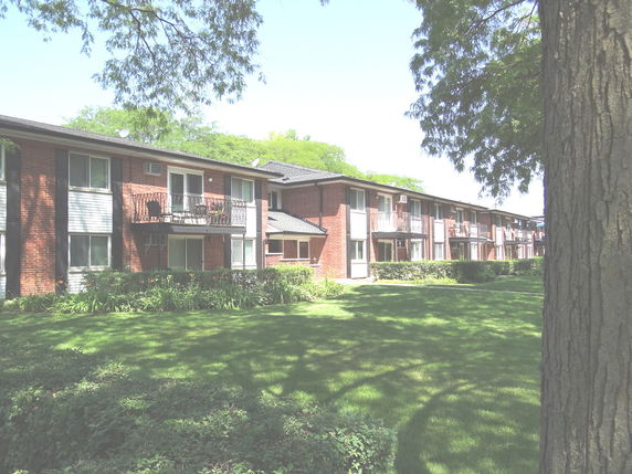 Front view of a two-story apartment building with balconies.