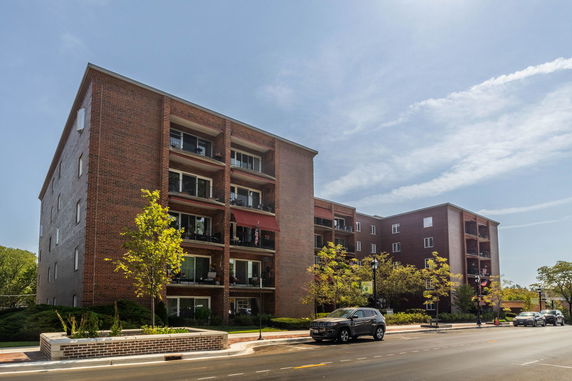 Front view of a multi-story brick apartment building.