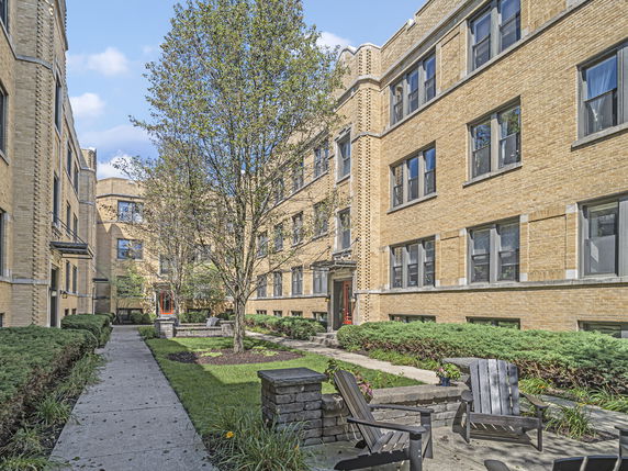 View of a multi-story brick building with a courtyard.