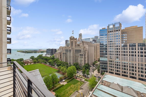 Panoramic view from a high vantage point showing tall buildings and a waterfront.