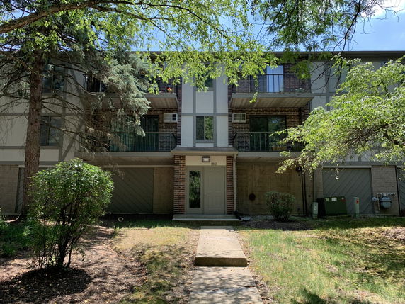 Front view of a multi-story residential building with balconies.