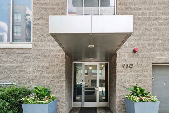 Front view of a building entrance with a canopy and glass door.