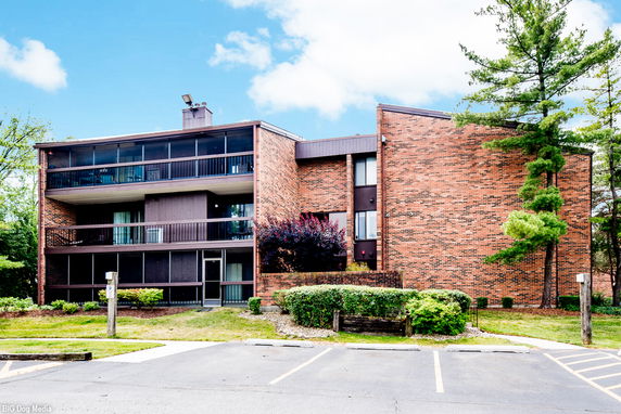 Front view of a multi-story brick building with balconies.