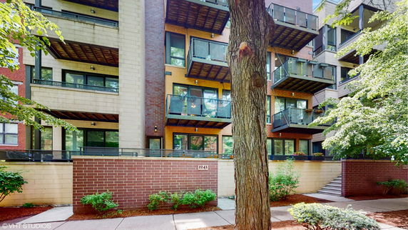 Front view of a multi-story residential building with balconies.