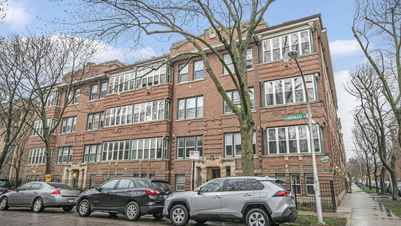 Front view of a multi-story brick apartment building.
