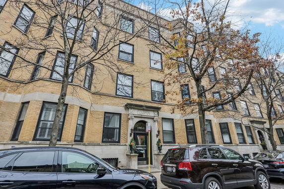 Front view of a multi-story brick apartment building.