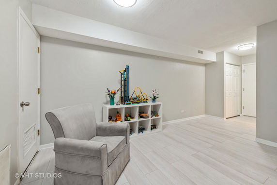 Interior of a play area with a chair and toys on shelves
