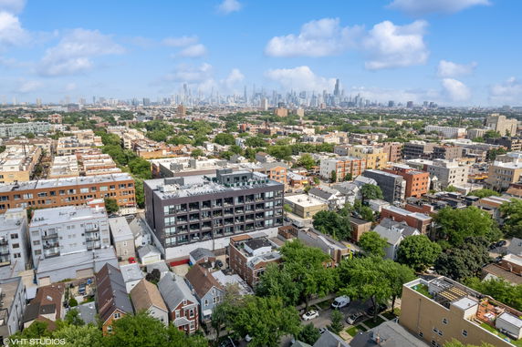Panoramic view of a cityscape with multiple buildings and trees.