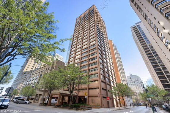 Front view of a tall, high-rise apartment building in an urban area.