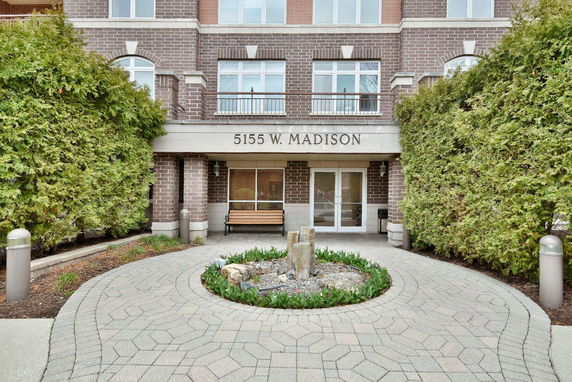 Entrance of a brick building with the address 5155 W. Madison above the door.