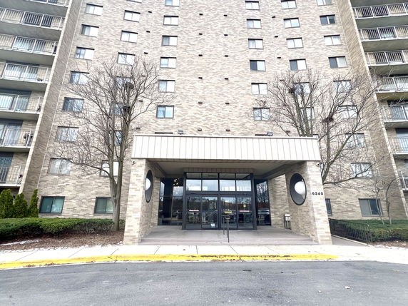 Front view of a multi-story residential building entrance.