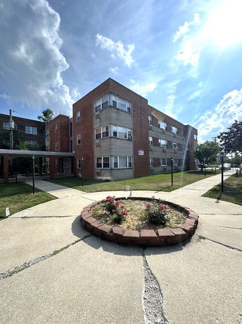 Front view of a multi-story brick apartment building.
