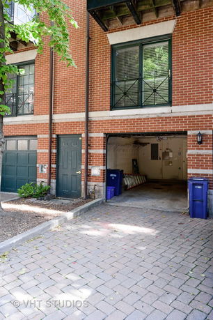 Front view of a building with an open garage and a brick exterior.
