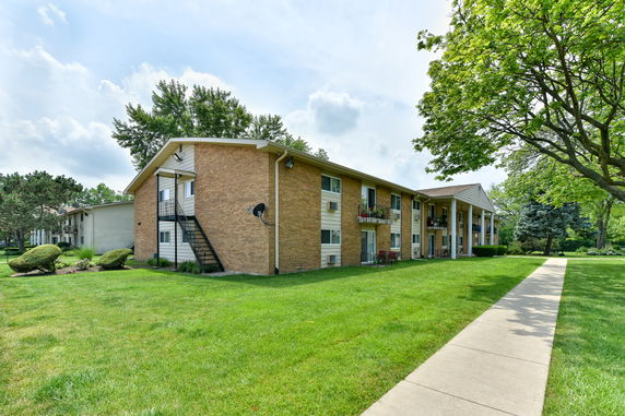 Front view of a two-story apartment building with brick exterior.