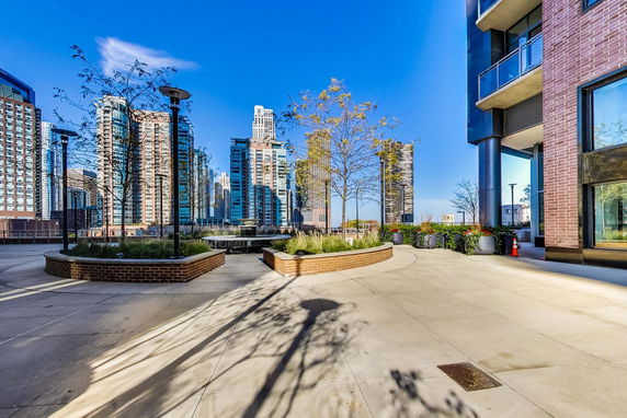 Urban landscape with tall buildings viewed from a terrace.