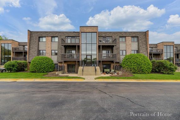 Front view of a multi-story residential building with balconies.