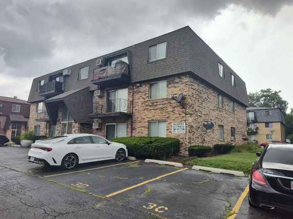 Front view of a three-story brick apartment building.