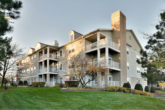 Front view of a multi-story residential building with balconies.