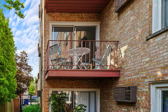 Exterior view of a building with a small balcony.