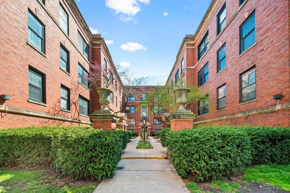 Front view of a multi-story brick apartment building.