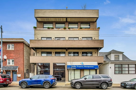 Front view of a multi-story building with balconies.