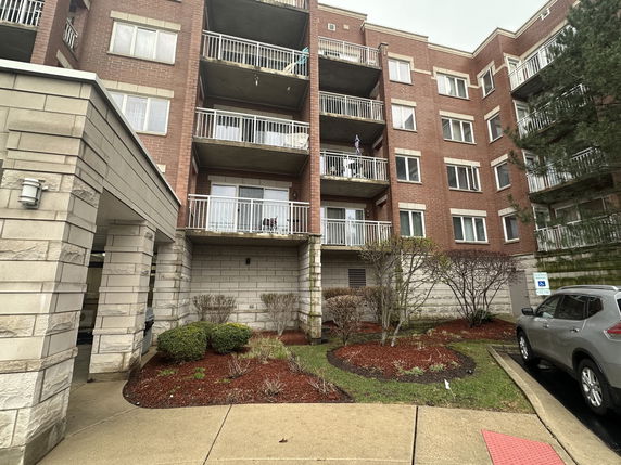 Front view of a multi-story residential building with balconies.