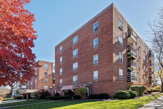 Front view of a multi-story brick apartment building.