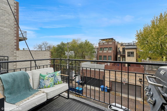 View from a rooftop featuring urban residential buildings and a street below.