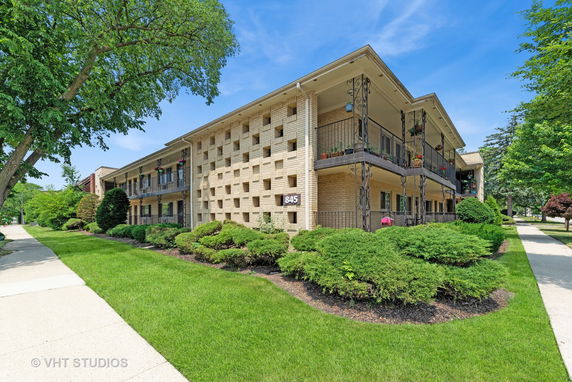 Front view of a two-story brick building with balconies.