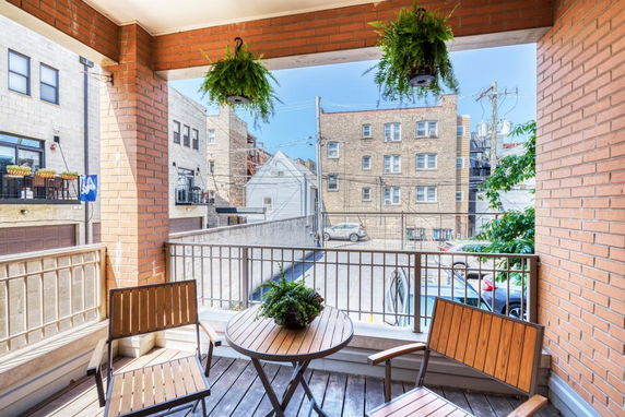 Balcony view showing surrounding apartment buildings.