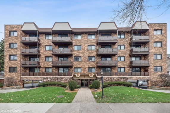 Front view of a multi-story building with balconies.