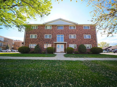 Front view of a three-story brick apartment building.