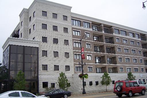 Front view of a multi-story apartment building with balconies.
