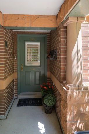 Entrance area of a brick building with a green door.