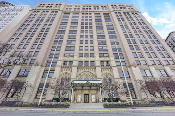 Front view of a tall building with an ornate entrance.