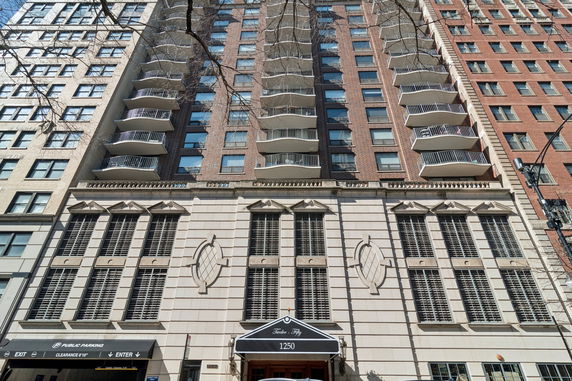 Front view of a multi-story building with balconies and a decorative facade.