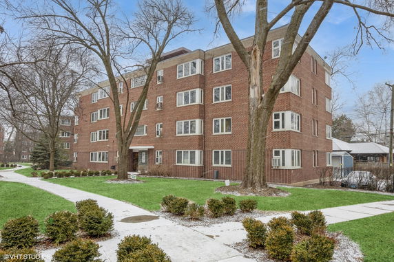 Front view of a four-story brick apartment building.