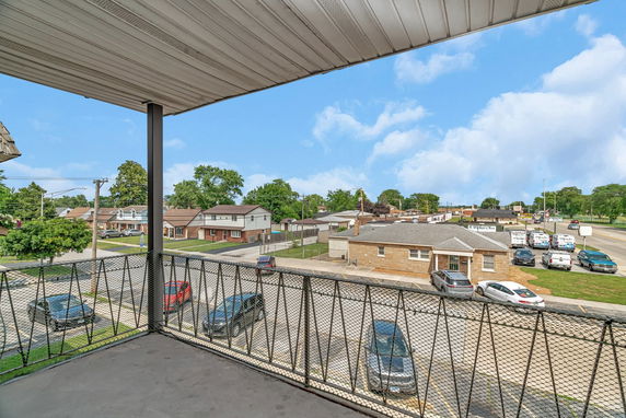 View of surrounding neighborhood from a covered balcony.