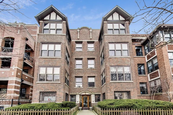 Front view of a multi-story brick apartment building.