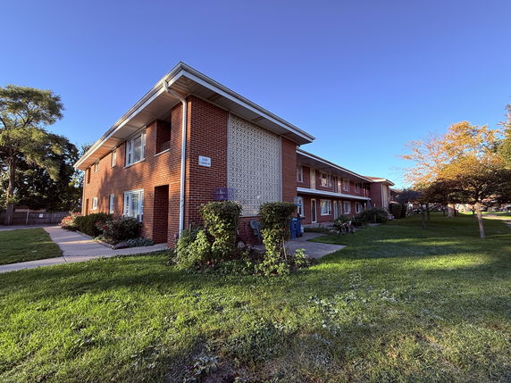 Front view of a two-story brick apartment building.