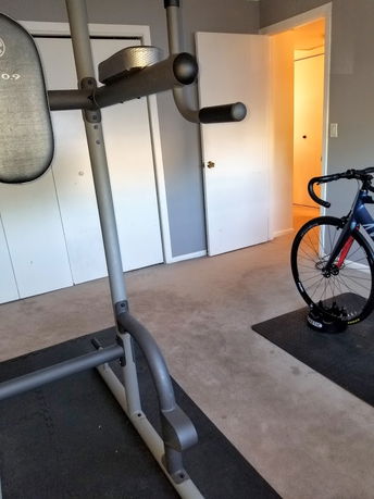 Room with exercise equipment and a bicycle.