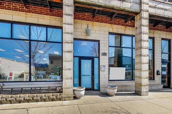 Front view of a building with large windows and a central entrance door.