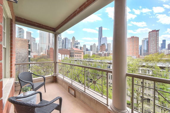 Balcony view of city skyline with skyscrapers in the background.