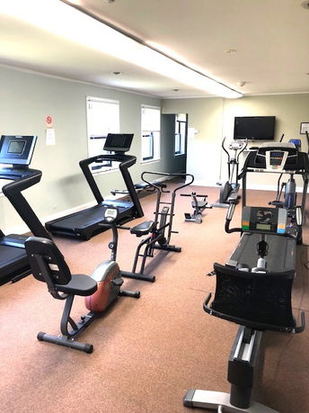 Indoor gym area with treadmills and exercise bikes.