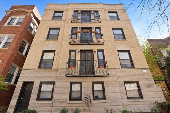 Front view of a multi-story residential building with balconies.